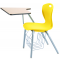 Stuhl mit Schreibtablar, abgebildet Modell D25A mit Bücherkorb, Sitzschale Gelb, Gestell Titan, Arbeitsplatte Ahorn